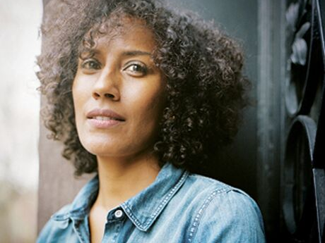Color photograph of Aracelis Girmay in a chambray shirt.