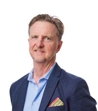 Headshot of Chad Davidson in a navy blue suit.