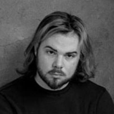 Black and white photo of Alexander Long against a grey background.