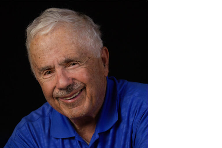 Color photograph of Charles Altieri smiling in a blue polo.