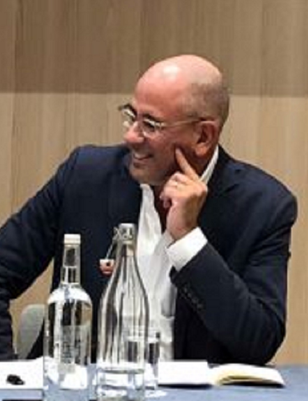 Color photograph of Charles Mahoney speaking on a panel.